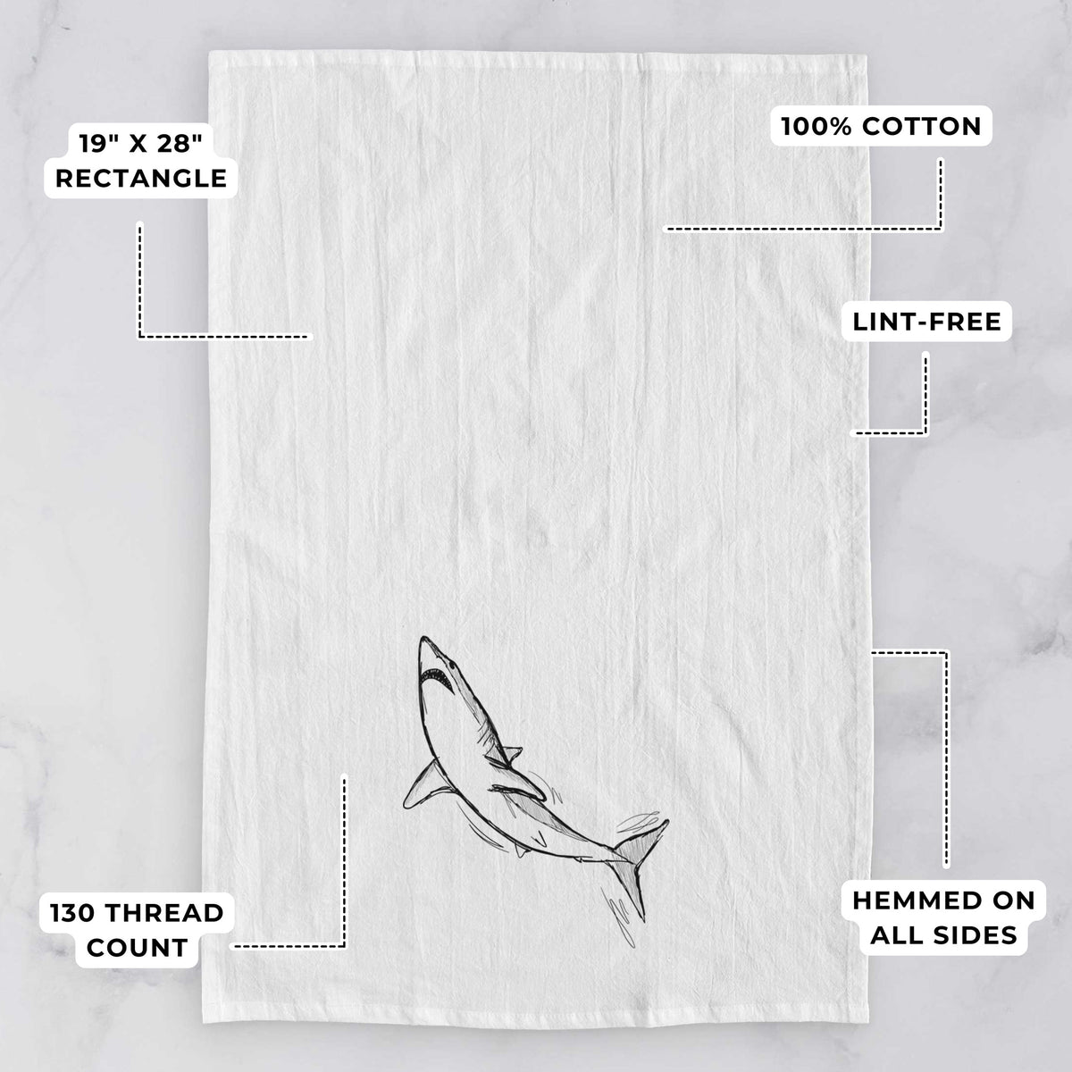 White tea towel printed with a black ink illustration of a shortfin mako shark diving, with feature labels: 19 by 28 inch rectangle, 100% cotton, lint-free, 130 thread count, hemmed on all sides.