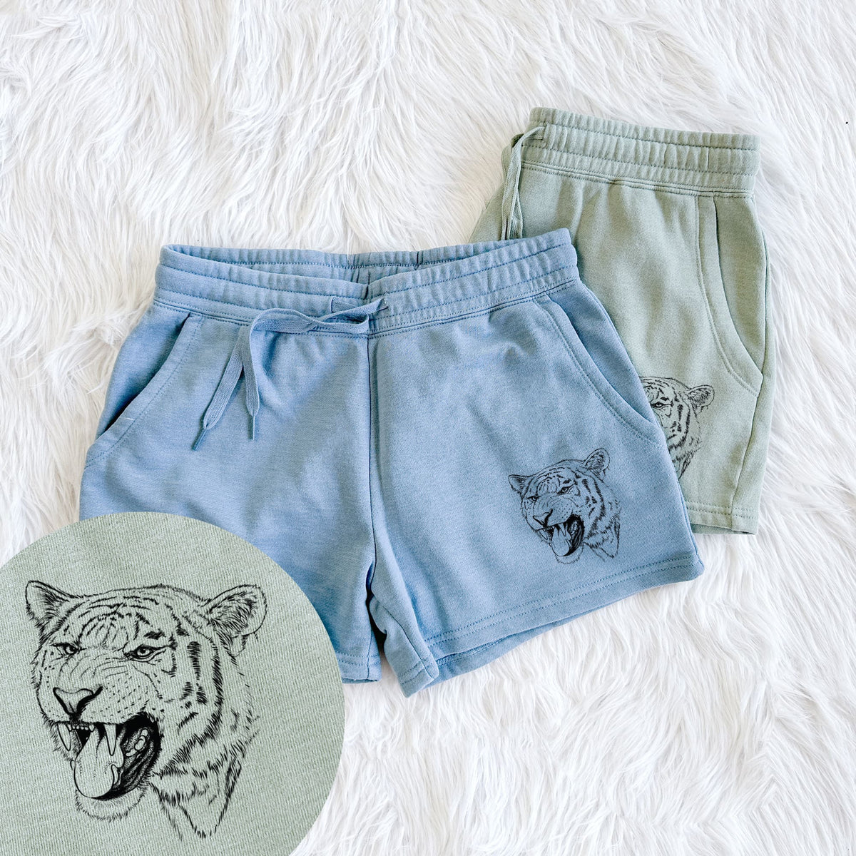 Two pairs of Cali Wave shorts in different colors printed with a detailed black ink portrait of a roaring Siberian tiger, with a close-up of the print.