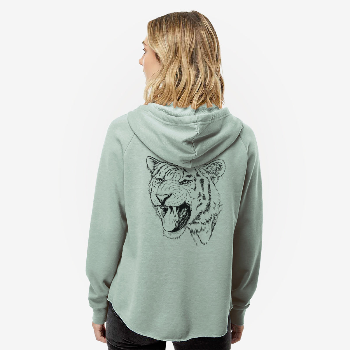 Woman wearing a sage green women's Cali Wave zip-up sweatshirt printed with a detailed black ink portrait of a roaring Siberian tiger, seen from behind.