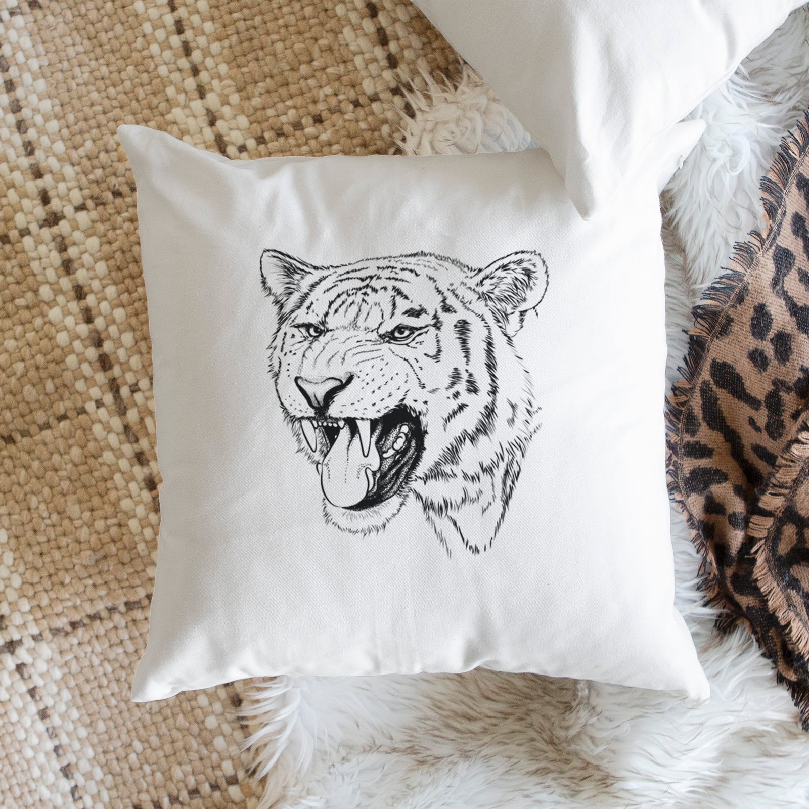 White pillow cover printed with a detailed black ink portrait of a roaring Siberian tiger, on a bench beside plants.