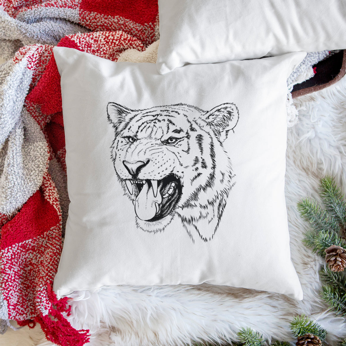 White pillow cover printed with a detailed black ink portrait of a roaring Siberian tiger, on a woven chair.