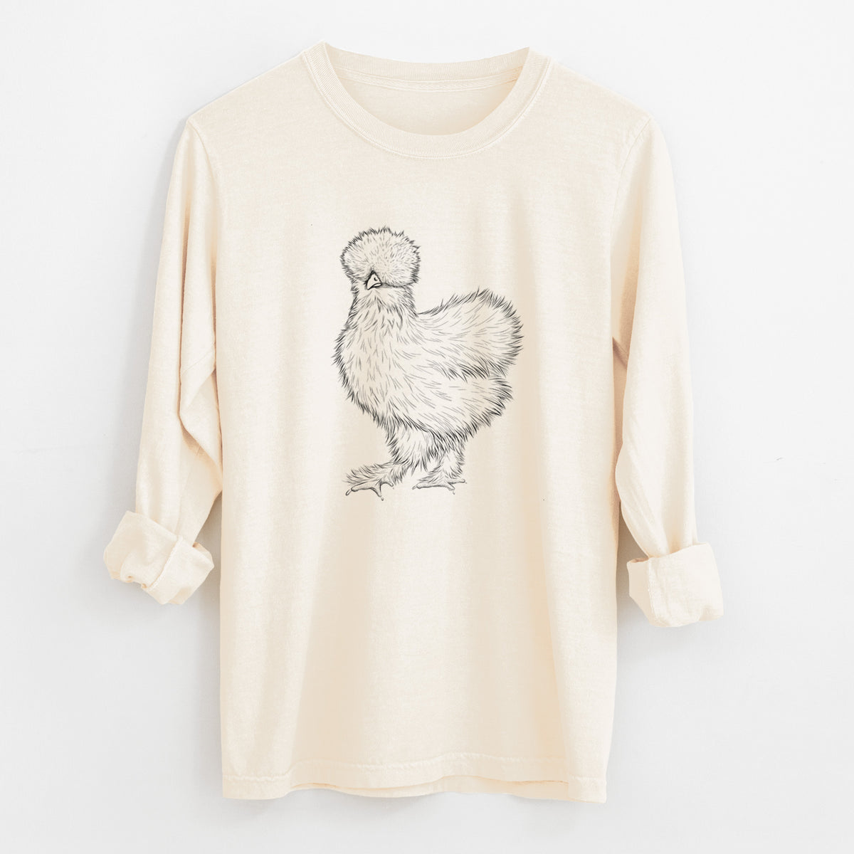 Ivory Comfort Colors long sleeve shirt laid flat with the cuffs rolled, printed with a black ink illustration of a fluffy silkie chicken.