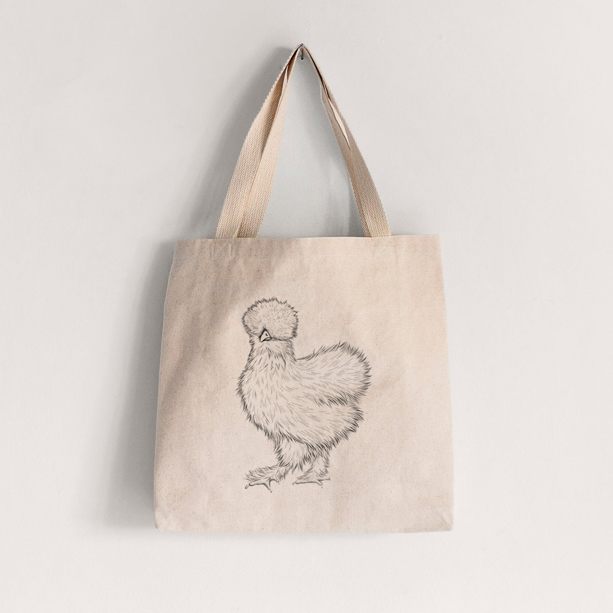 Natural canvas tote bag printed with a black ink illustration of a fluffy silkie chicken.