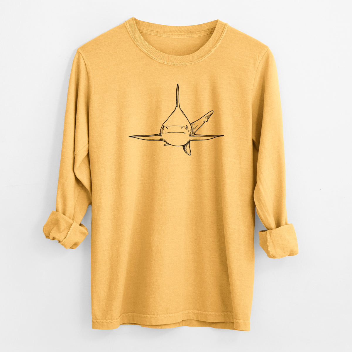 Golden wheat yellow Comfort Colors long sleeve shirt laid flat with the cuffs rolled, printed with a black ink illustration of a silvertip shark swimming head-on.