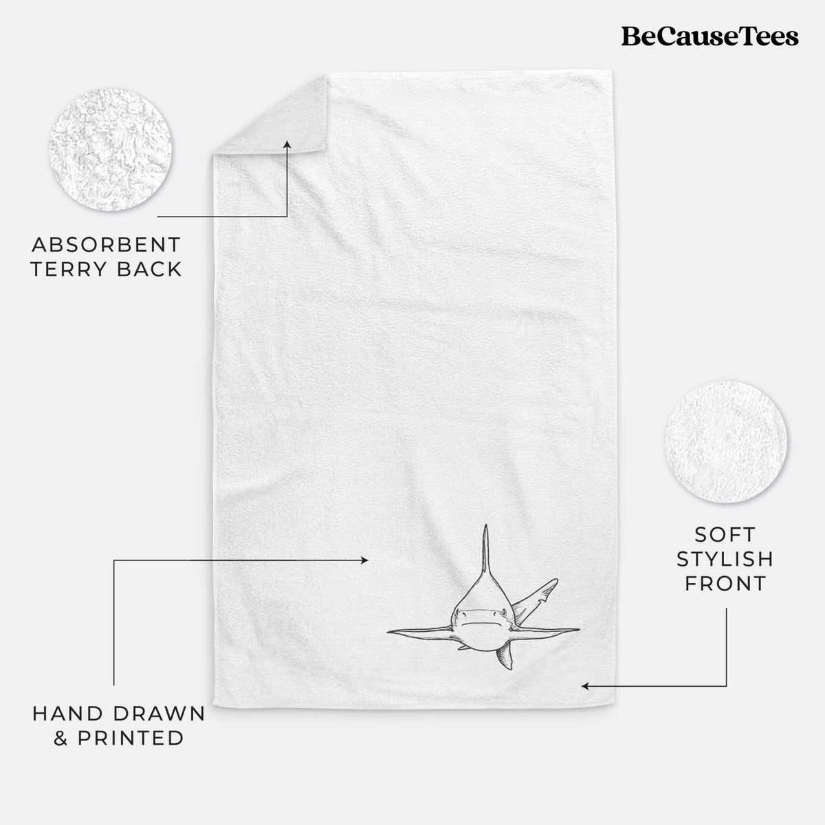 White hand towel printed with a black ink illustration of a silvertip shark swimming head-on.