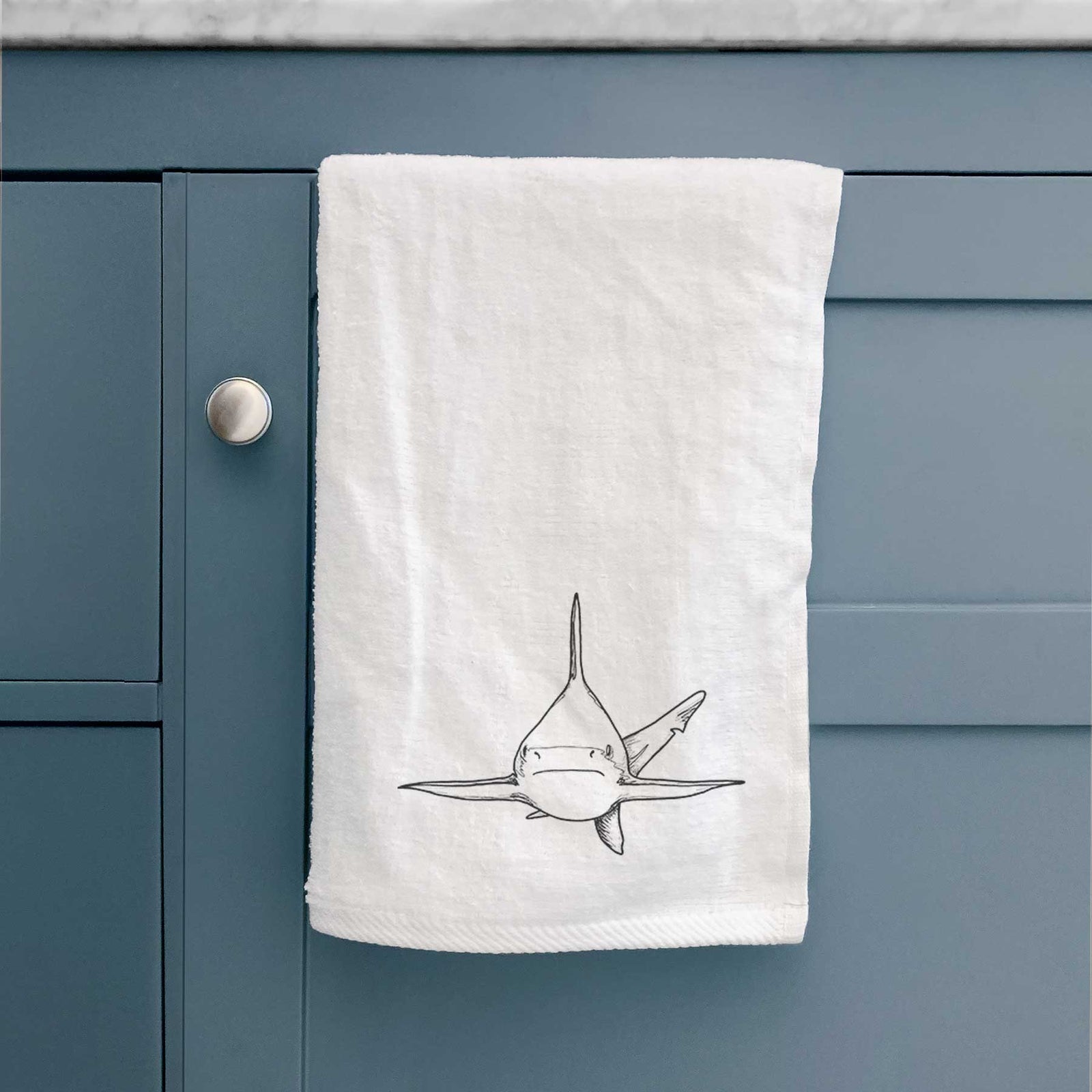 White hand towel printed with a black ink illustration of a silvertip shark swimming head-on.
