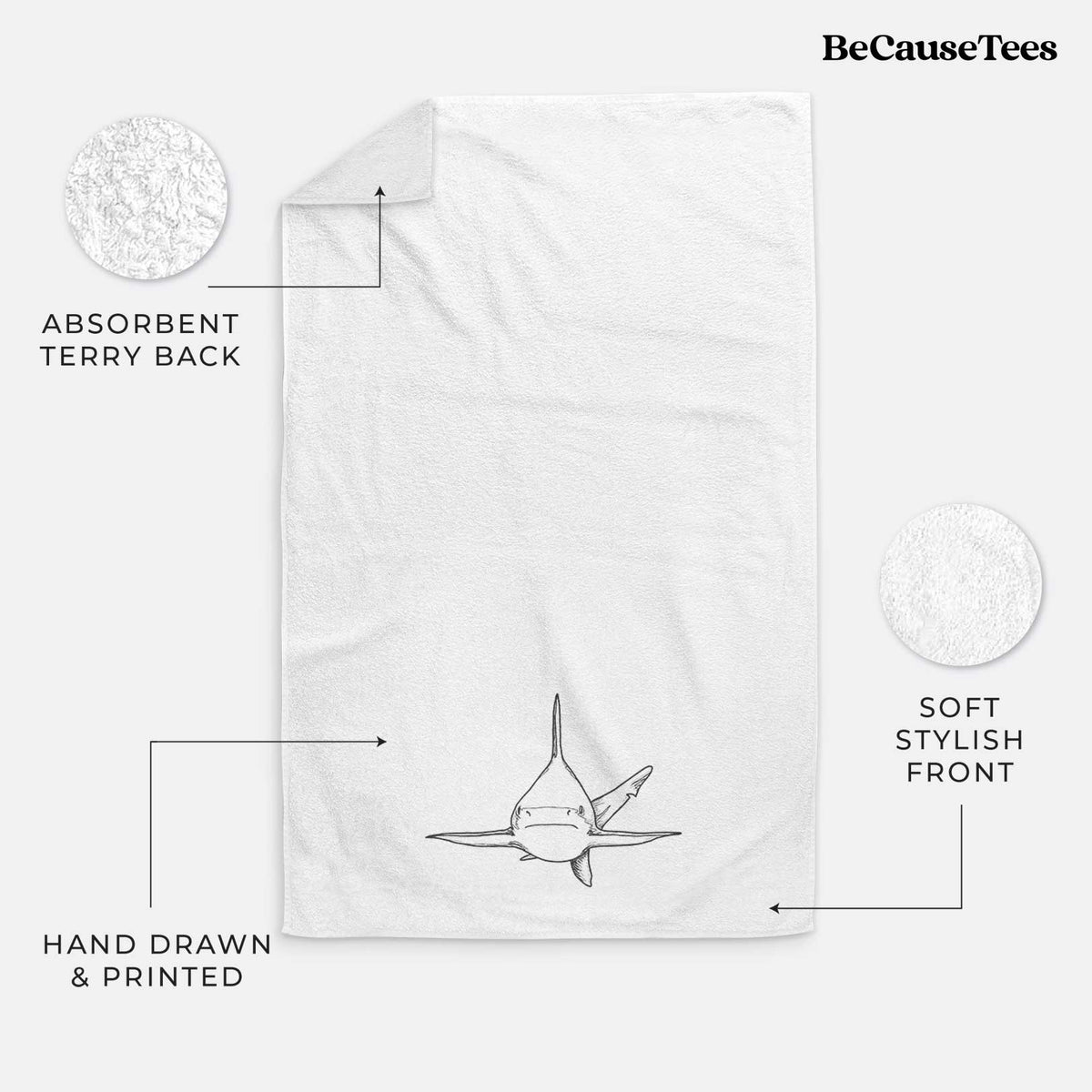White hand towel printed with a black ink illustration of a silvertip shark swimming head-on.