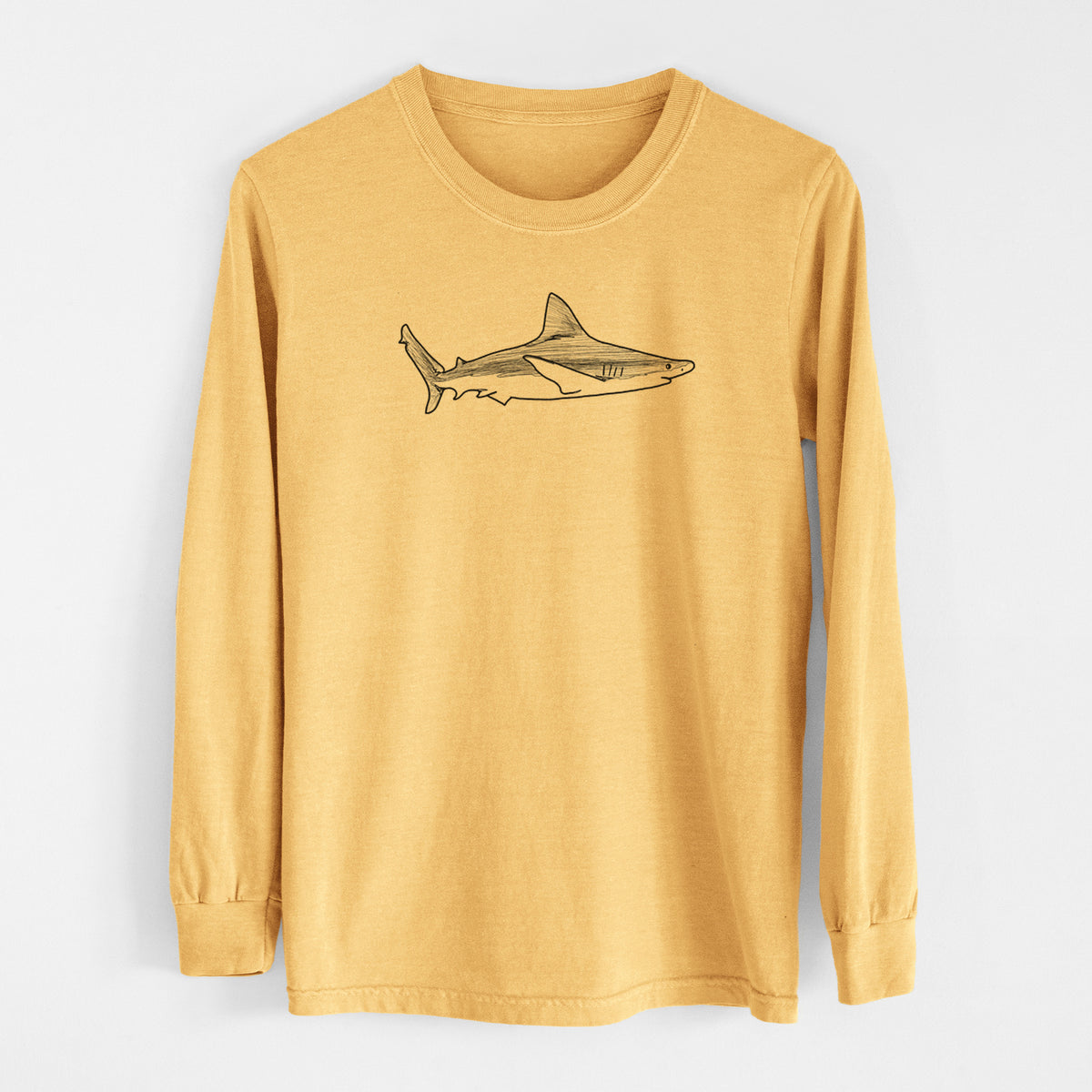 Golden wheat yellow Comfort Colors long sleeve shirt laid flat, printed with a black ink illustration of a silvertip shark swimming in profile.
