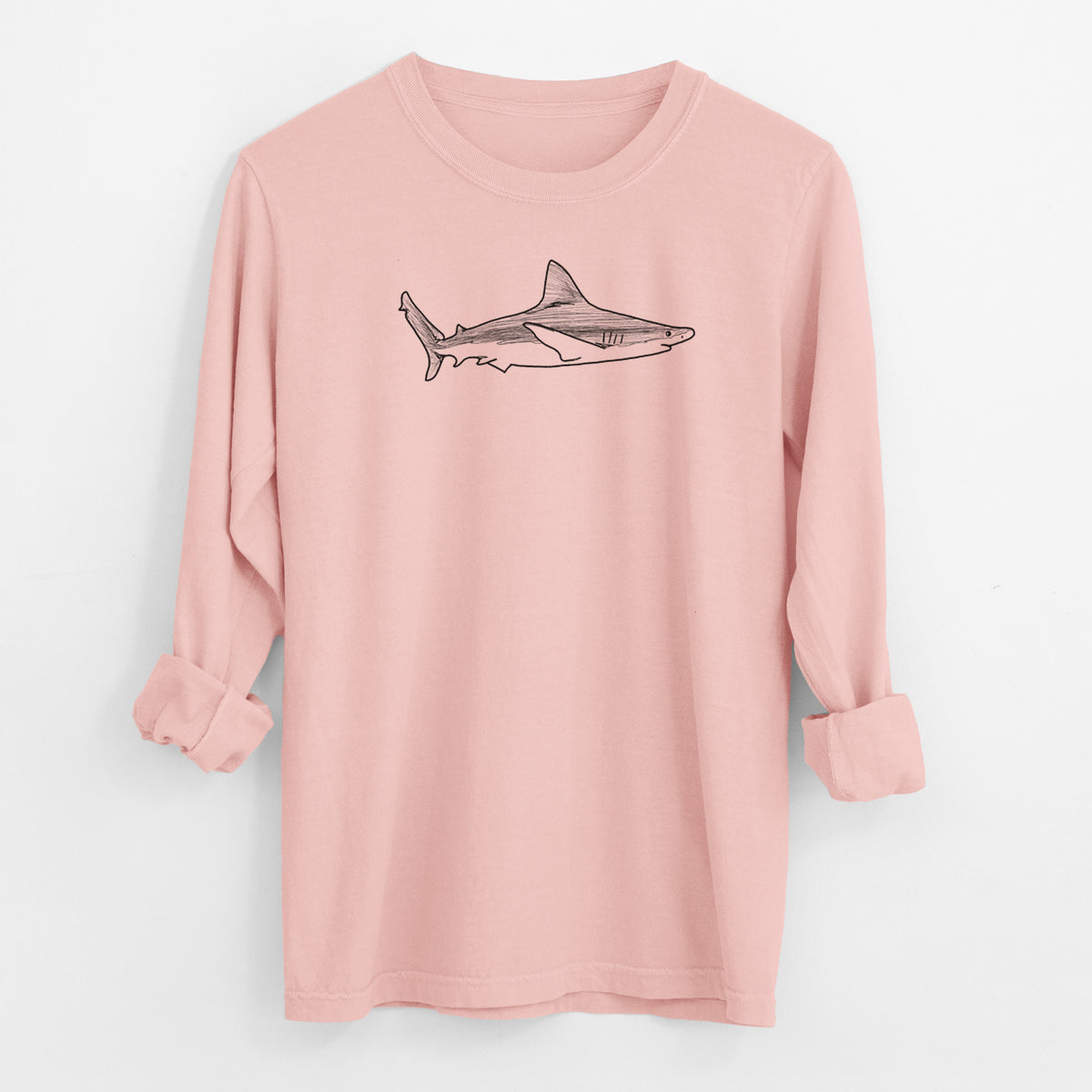 Peachy Comfort Colors long sleeve shirt laid flat with the cuffs rolled, printed with a black ink illustration of a silvertip shark swimming in profile.