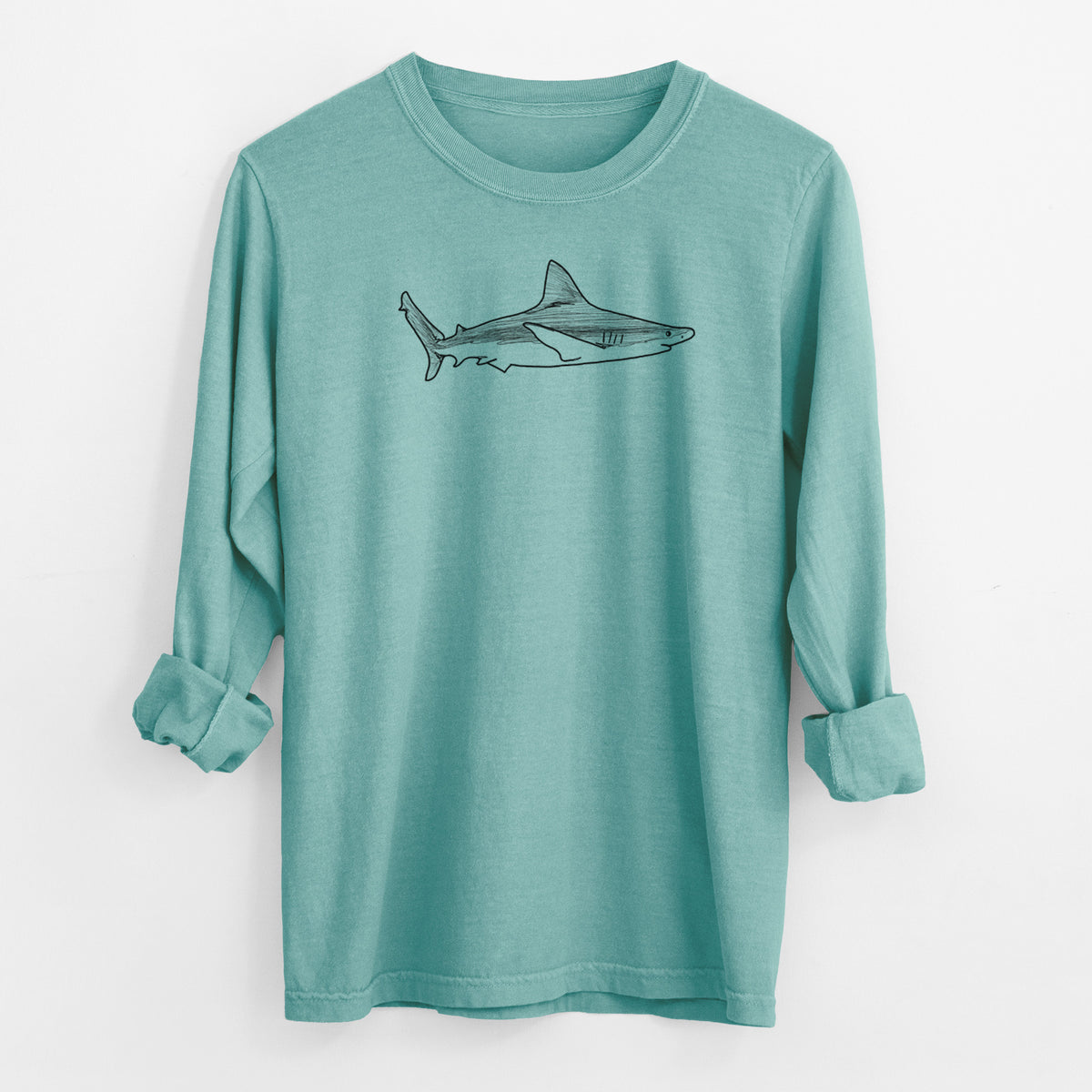 Reef green Comfort Colors long sleeve shirt laid flat with the cuffs rolled, printed with a black ink illustration of a silvertip shark swimming in profile.