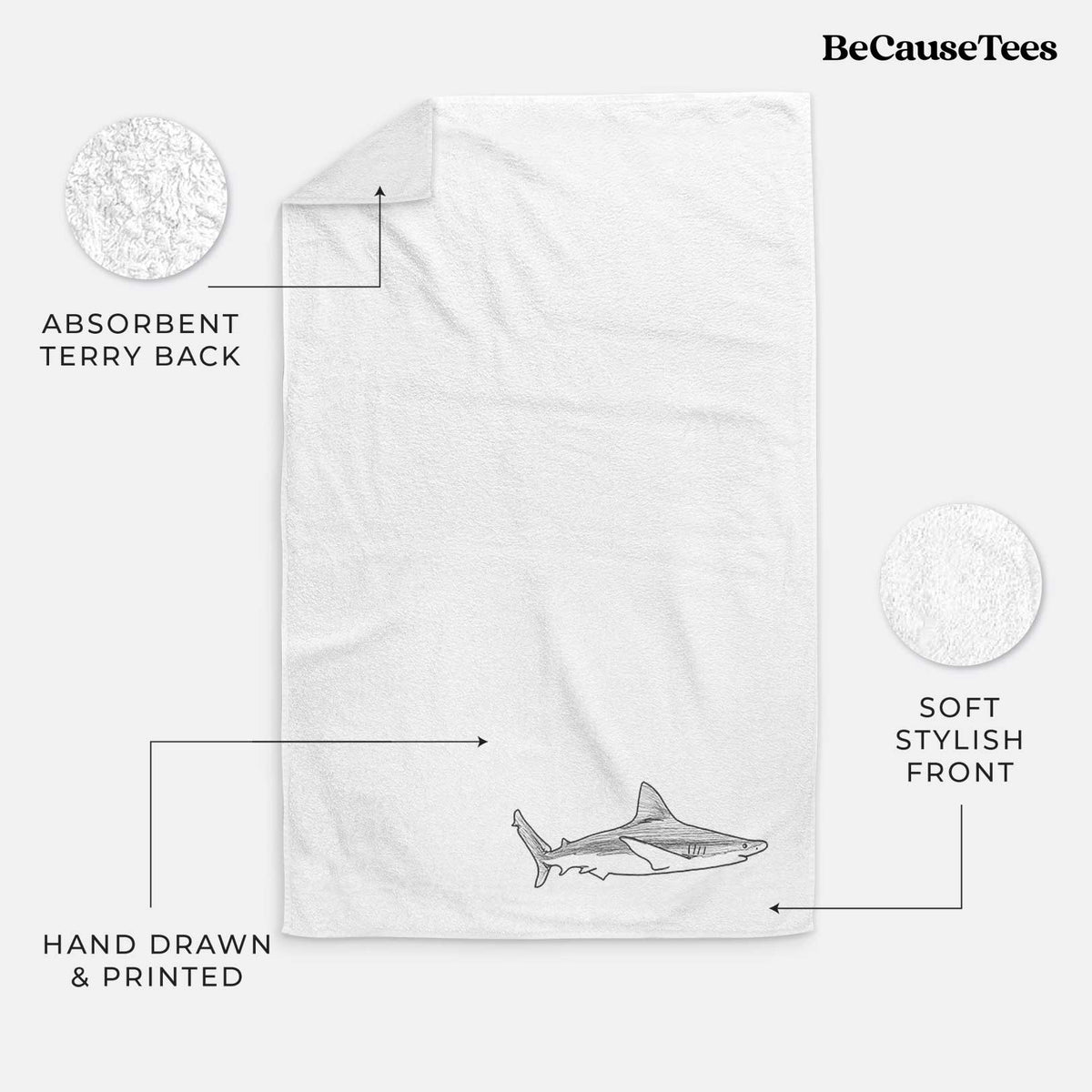 White hand towel printed with a black ink illustration of a silvertip shark swimming in profile.
