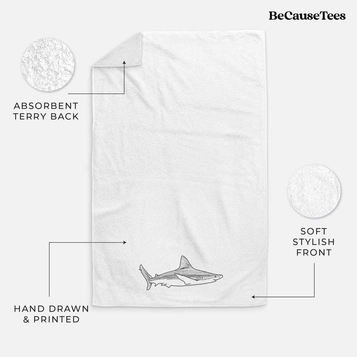 White hand towel printed with a black ink illustration of a silvertip shark swimming in profile.