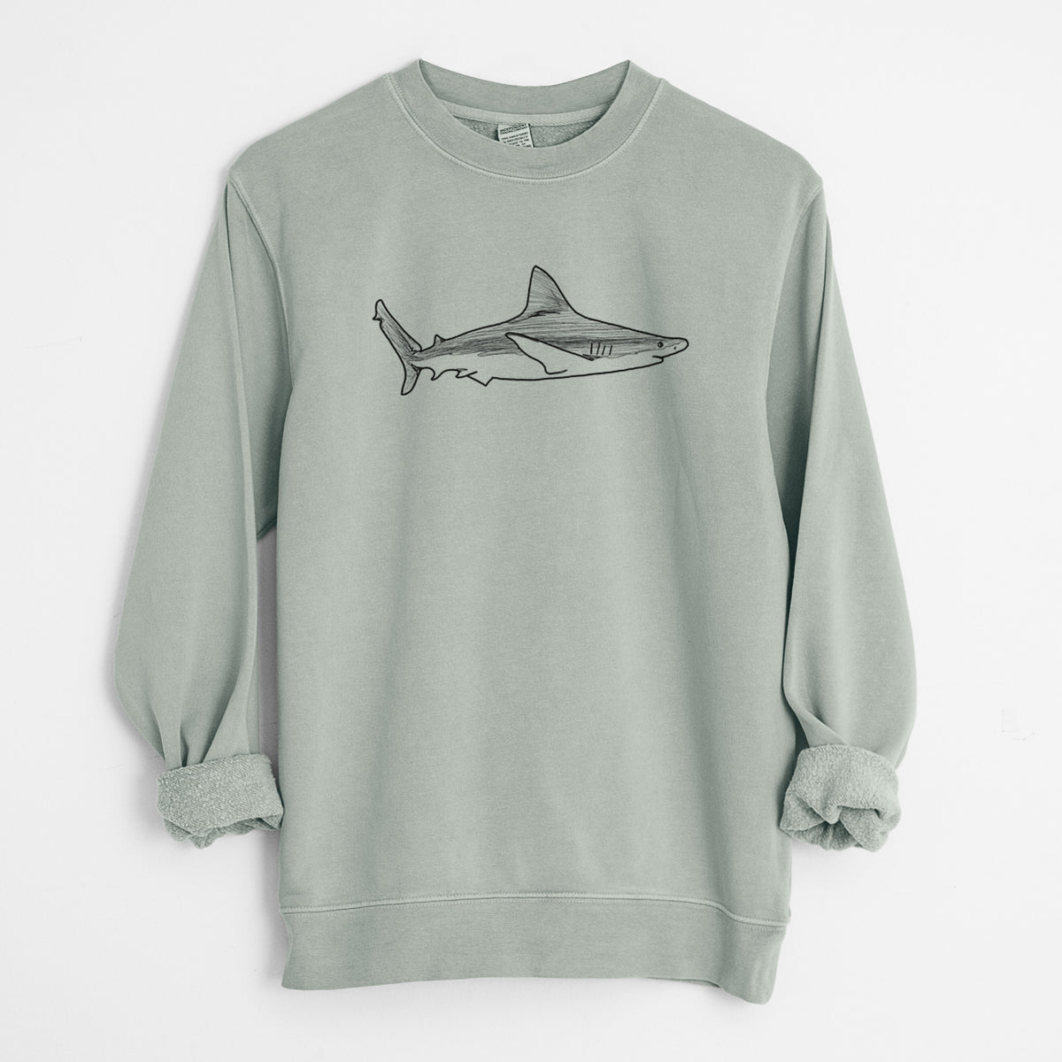 Sage green pigment dyed crewneck sweatshirt laid flat with the sleeves rolled, printed with a black ink illustration of a silvertip shark swimming in profile.