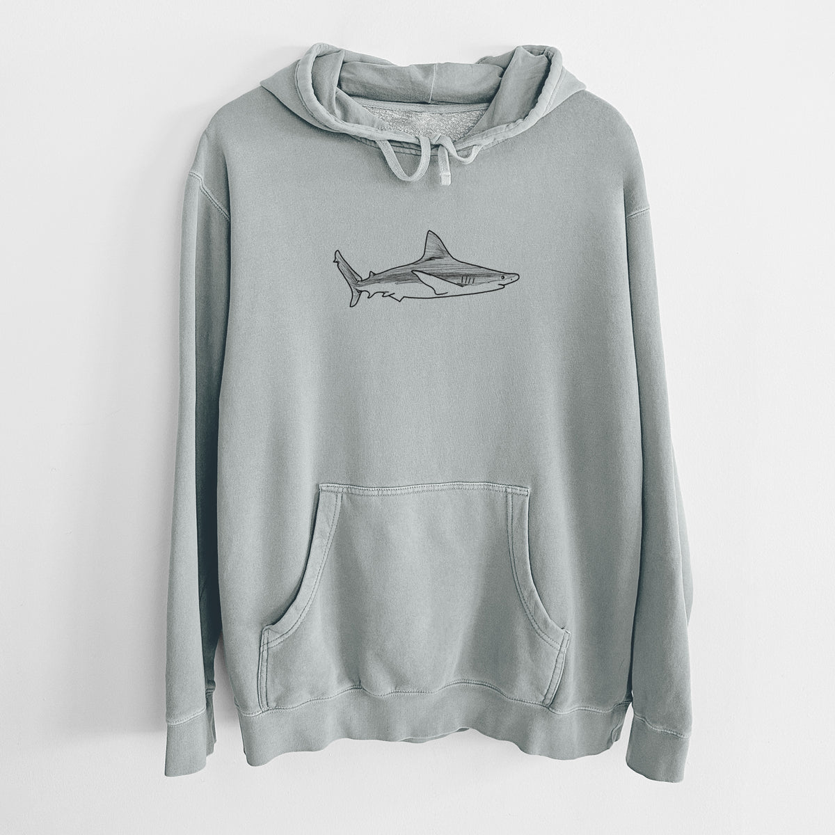 Sage green pigment dyed hoodie laid flat, printed with a black ink illustration of a silvertip shark swimming in profile.