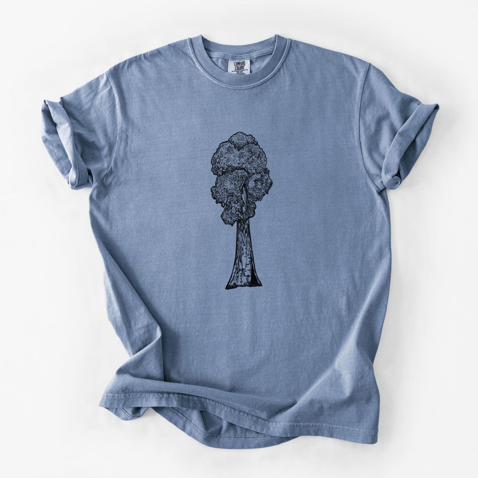 Blue jean Comfort Colors t-shirt laid flat, printed with a black ink illustration of a single giant sequoia tree.