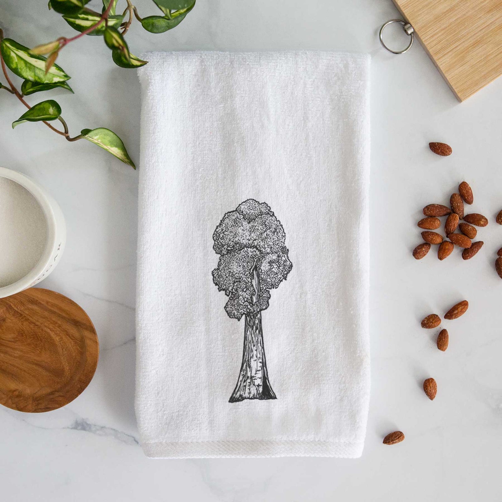 White hand towel printed with a black ink illustration of a single giant sequoia tree.