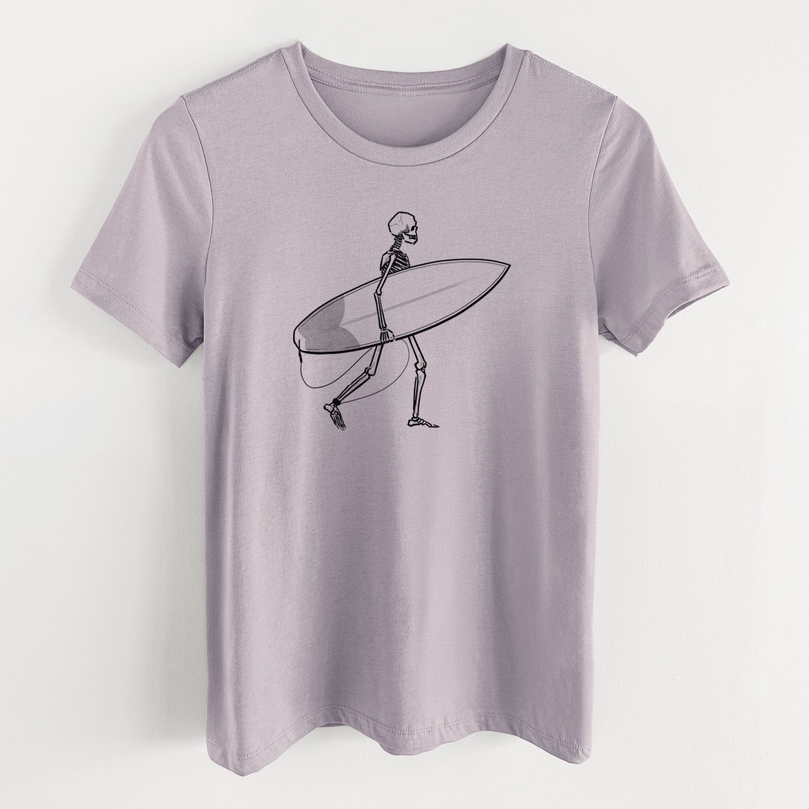 Light violet women's relaxed fit cotton t-shirt laid flat, printed with a black ink skeleton walking while carrying a surfboard.