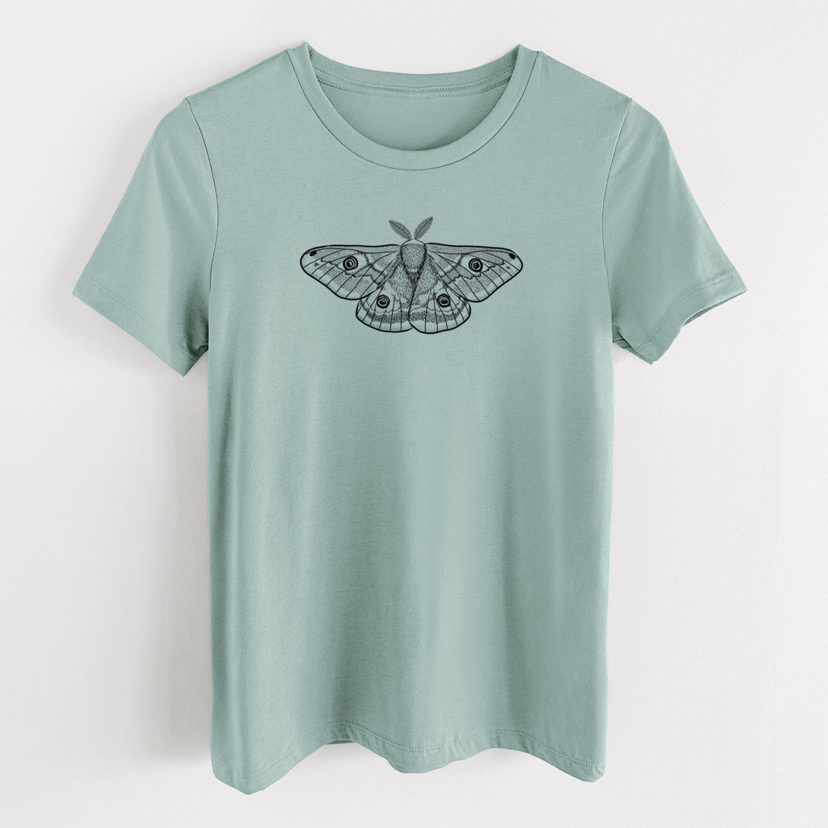 Dusty blue women's relaxed fit cotton t-shirt laid flat, printed with a detailed black ink illustration of a small emperor moth with eyespots on its wings.