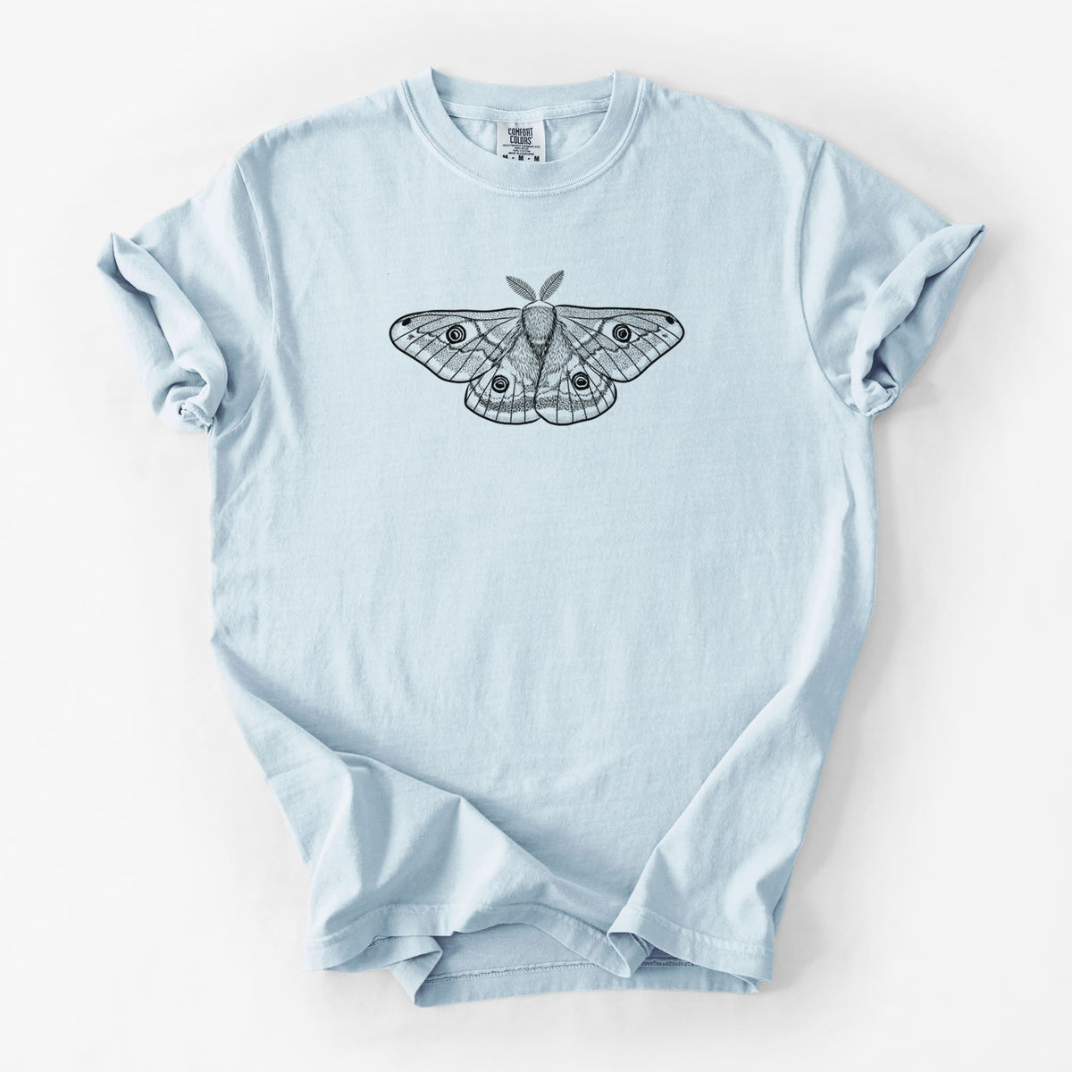 Chambray blue Comfort Colors t-shirt laid flat, printed with a detailed black ink illustration of a small emperor moth with eyespots on its wings.