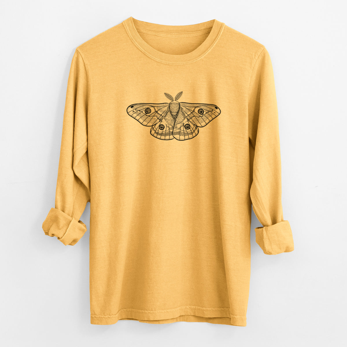 Golden wheat yellow Comfort Colors long sleeve shirt laid flat with the cuffs rolled, printed with a detailed black ink illustration of a small emperor moth with eyespots on its wings.