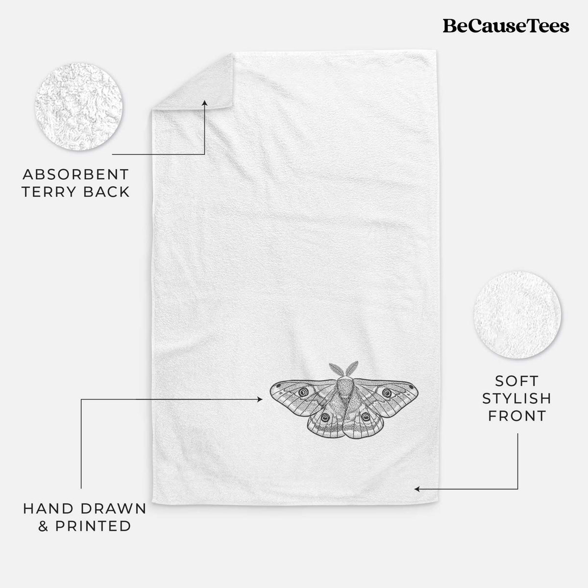White hand towel printed with a detailed black ink illustration of a small emperor moth with eyespots on its wings.
