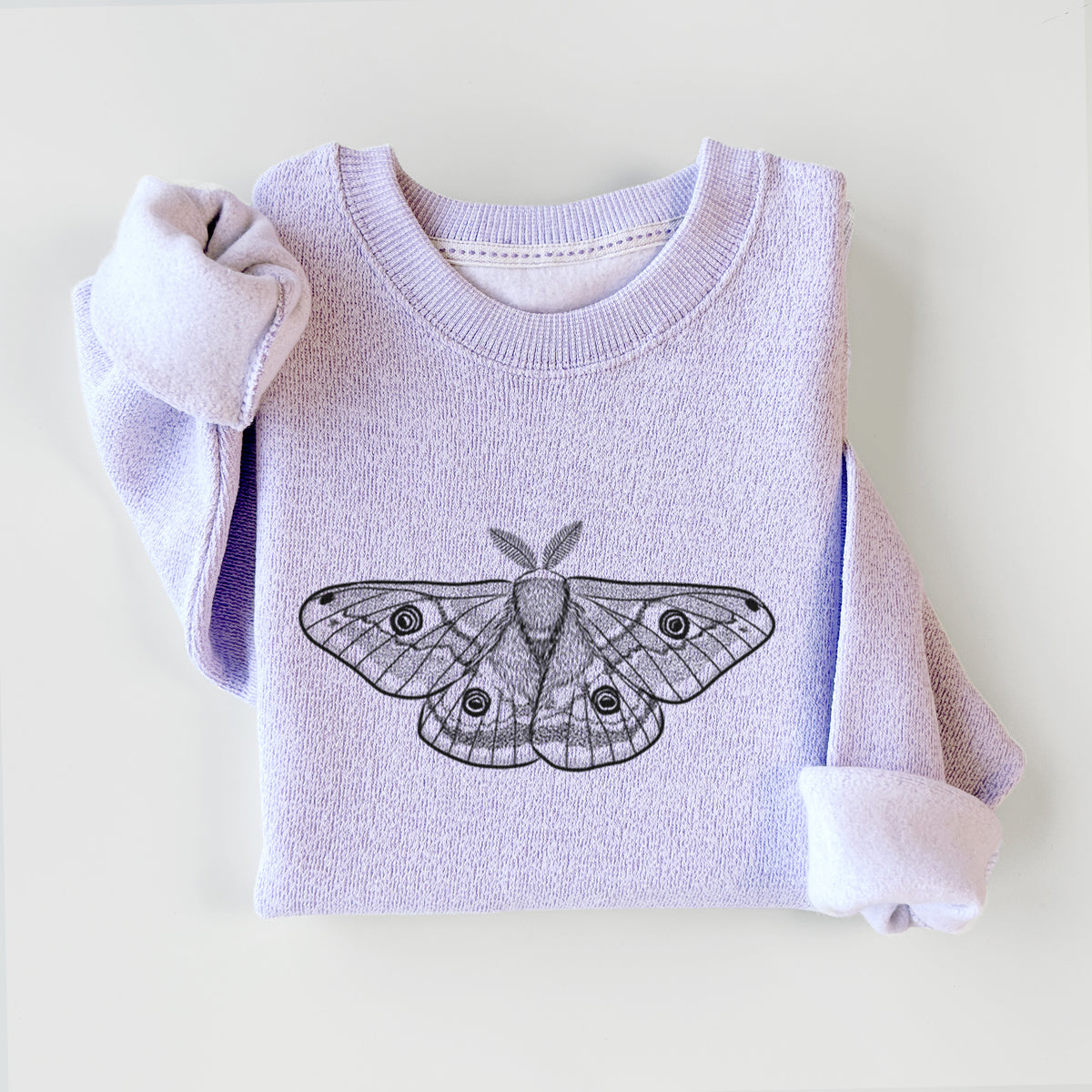Ice purple knit sweatshirt printed with a detailed black ink illustration of a small emperor moth with eyespots on its wings, styled flat.