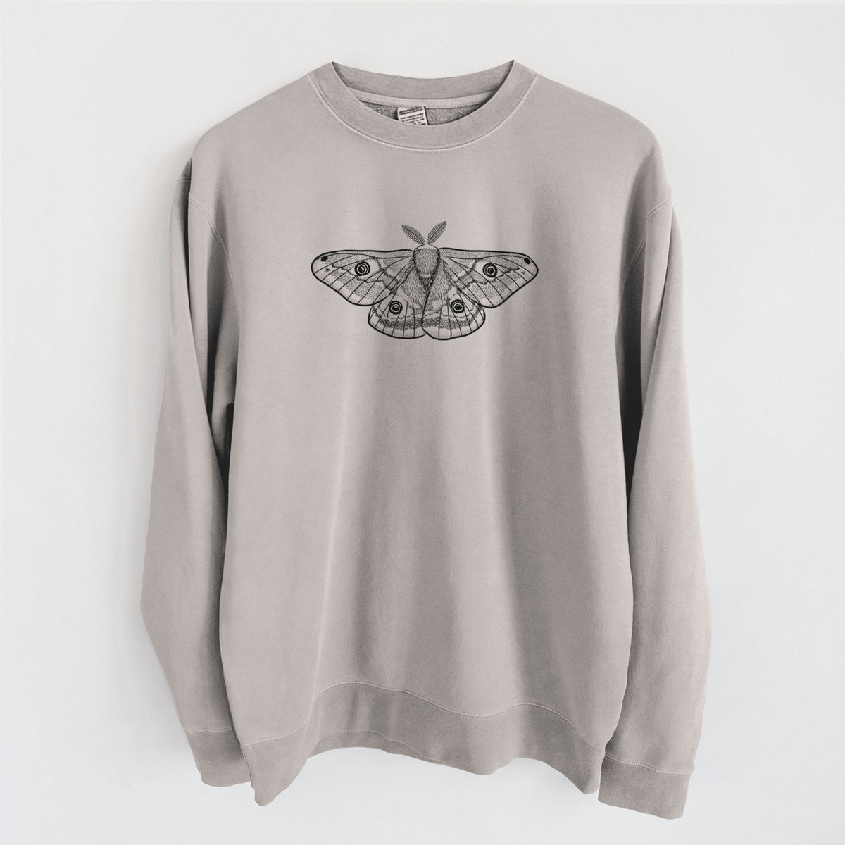 Cement grey pigment dyed crewneck sweatshirt laid flat, printed with a detailed black ink illustration of a small emperor moth with eyespots on its wings.