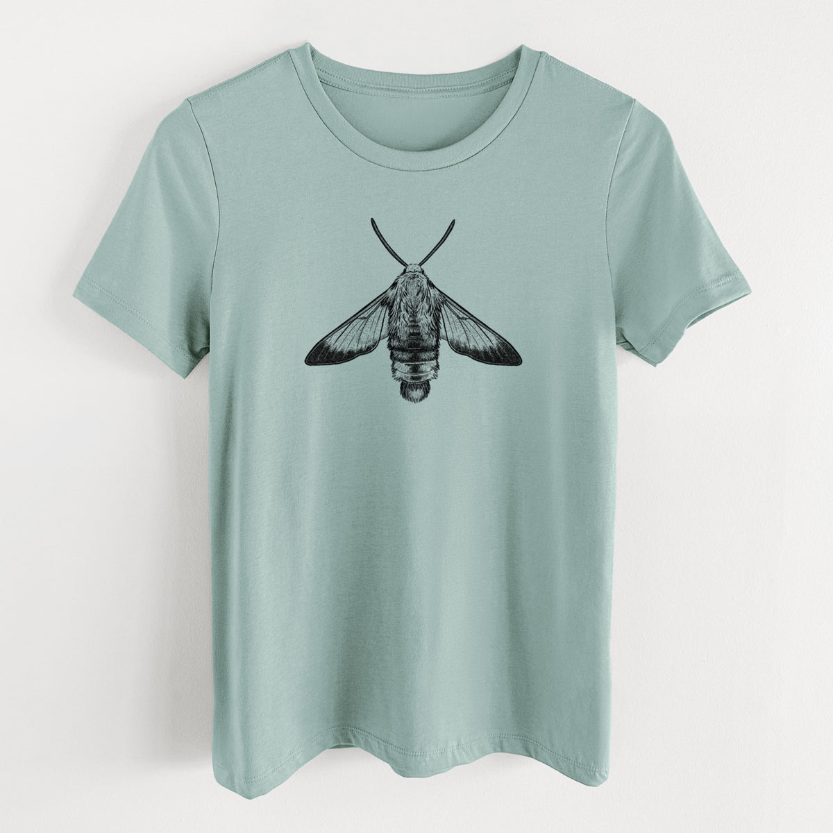 Dusty blue women's relaxed fit cotton t-shirt laid flat, printed with a detailed black ink illustration of a snowberry clearwing moth, seen from above.