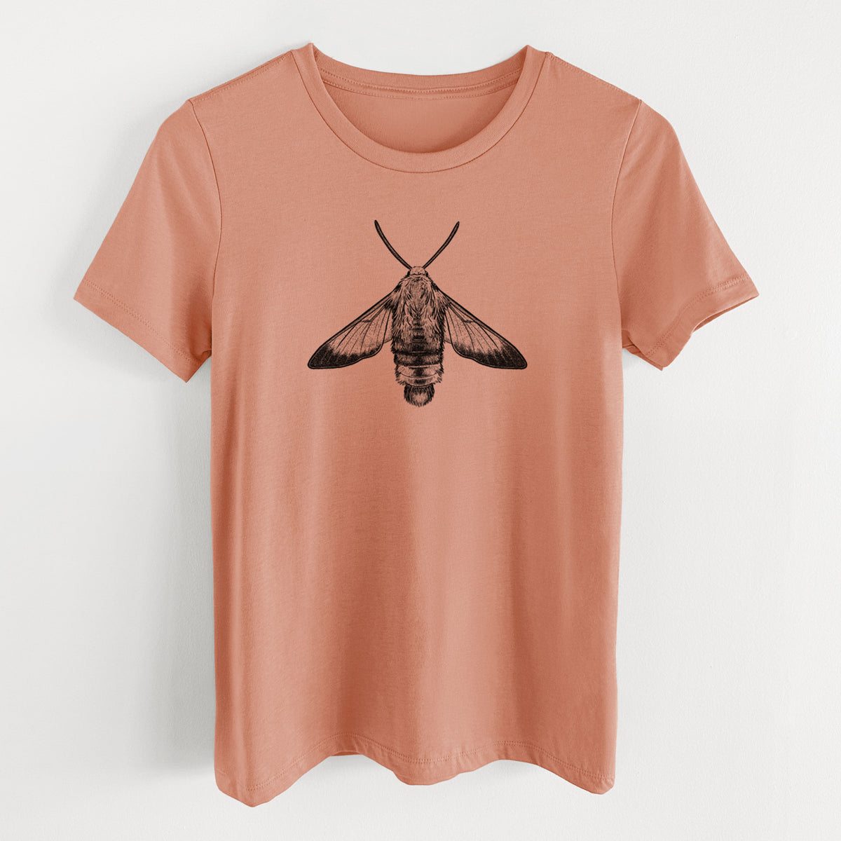 Terracotta orange women's relaxed fit cotton t-shirt laid flat, printed with a detailed black ink illustration of a snowberry clearwing moth, seen from above.