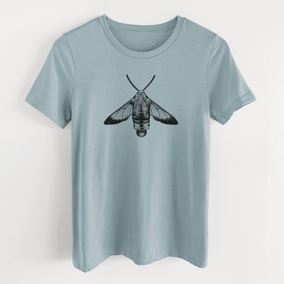Vintage denim women's relaxed fit cotton t-shirt laid flat, printed with a detailed black ink illustration of a snowberry clearwing moth, seen from above.