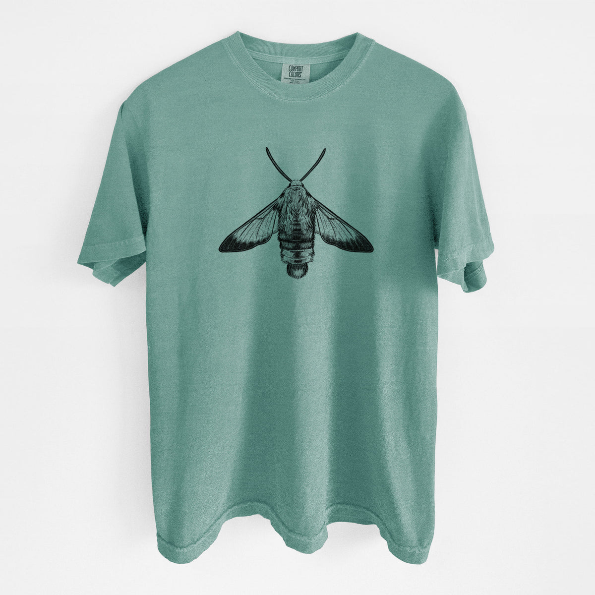 Reef green Comfort Colors t-shirt laid flat, printed with a detailed black ink illustration of a snowberry clearwing moth, seen from above.