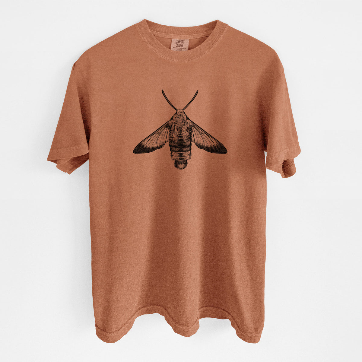 Yam burnt orange Comfort Colors t-shirt laid flat, printed with a detailed black ink illustration of a snowberry clearwing moth, seen from above.
