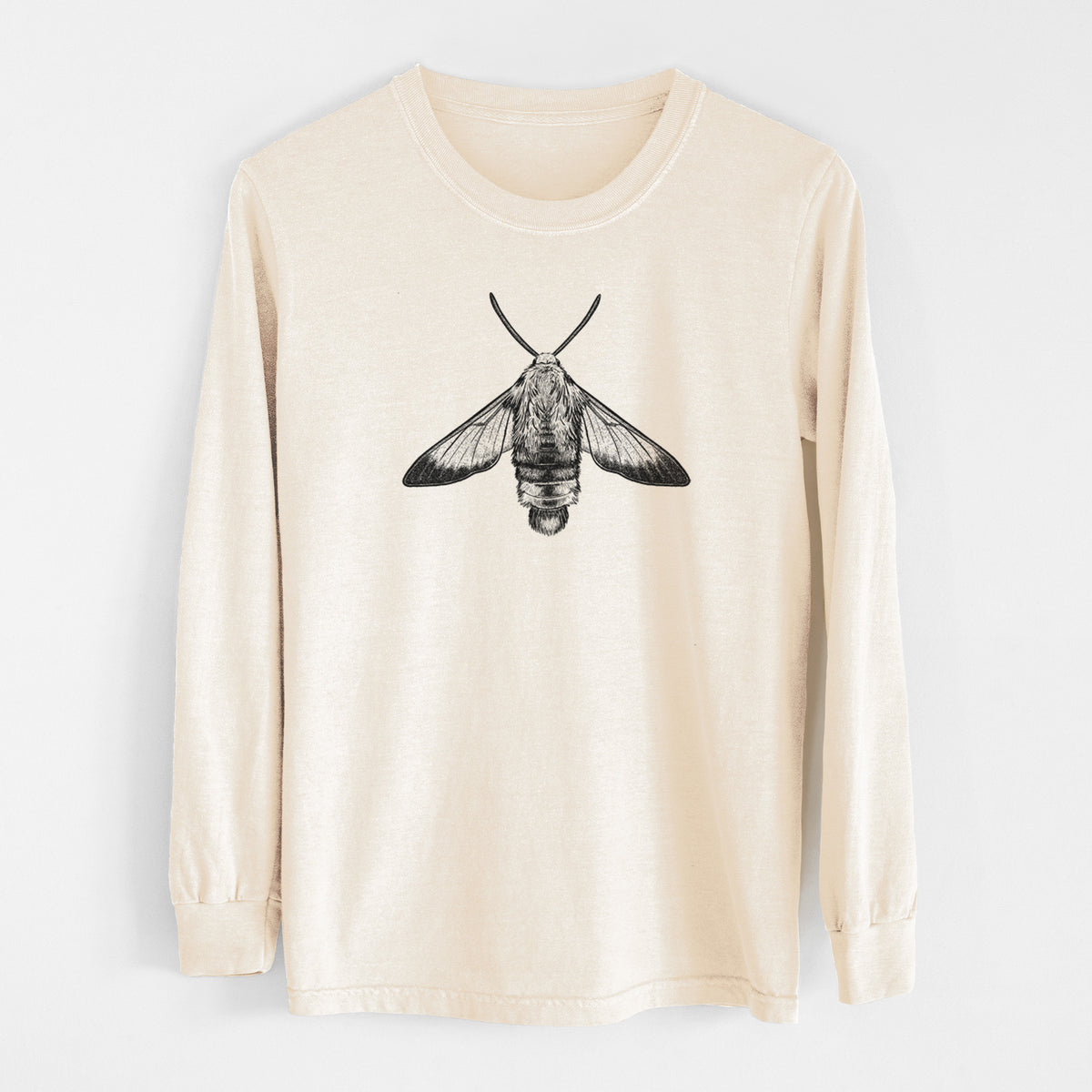 Ivory Comfort Colors long sleeve shirt laid flat, printed with a detailed black ink illustration of a snowberry clearwing moth, seen from above.