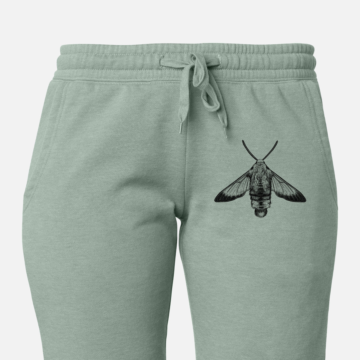 Front of sage green Cali Wave sweatpants, printed with a detailed black ink illustration of a snowberry clearwing moth, seen from above on the leg.