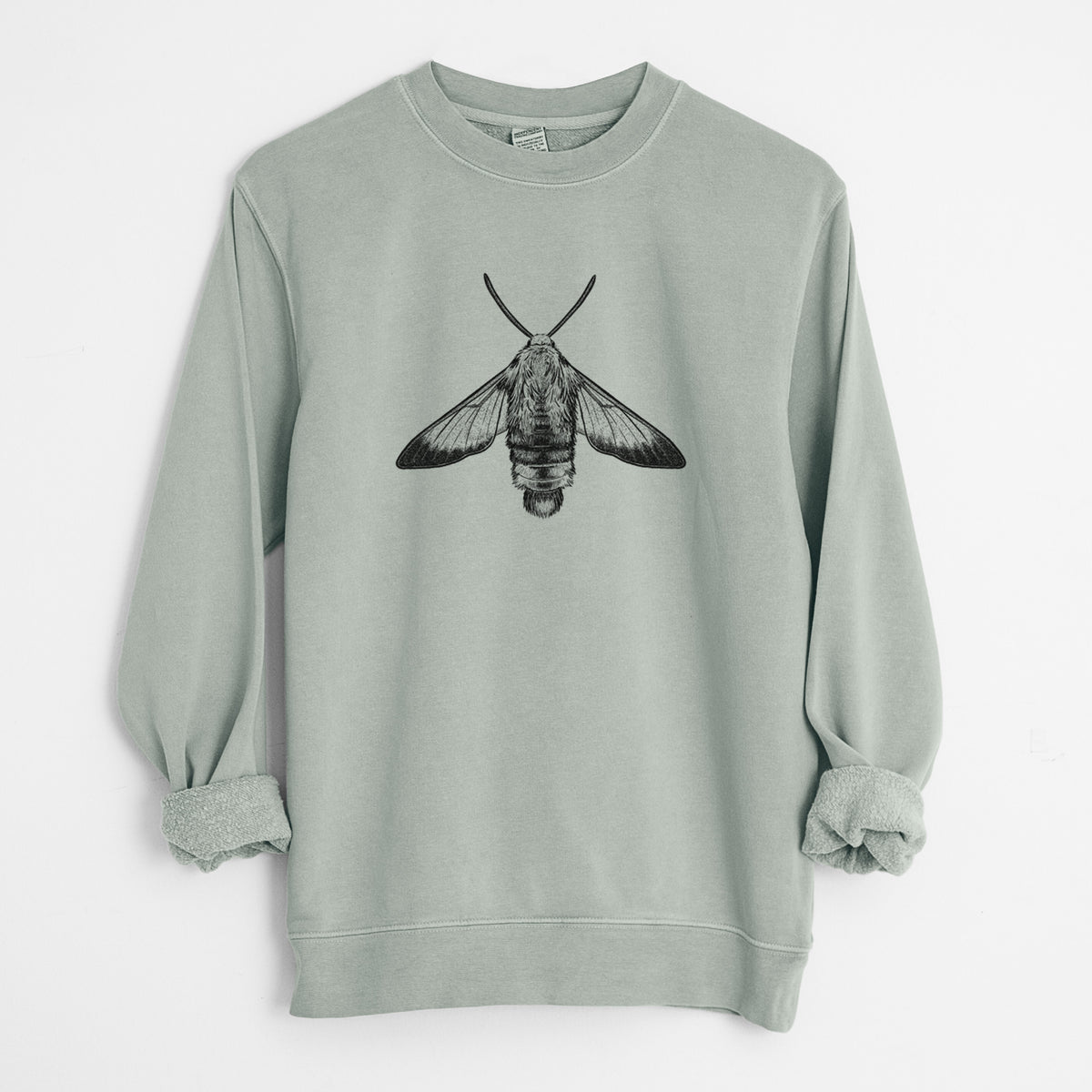 Sage green pigment dyed crewneck sweatshirt laid flat with the sleeves rolled, printed with a detailed black ink illustration of a snowberry clearwing moth, seen from above.
