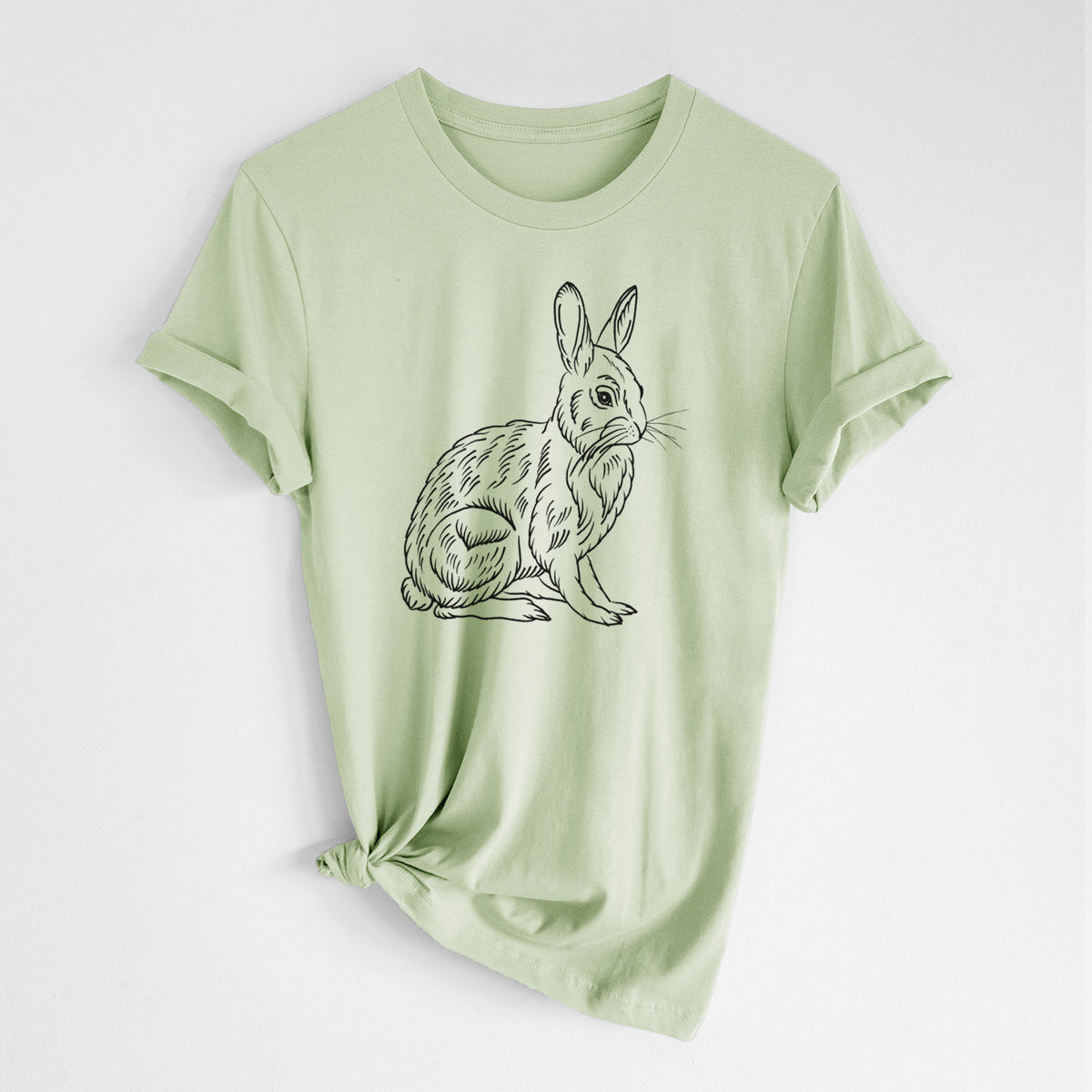 Spring green lightweight cotton t-shirt laid flat with the sleeves rolled, printed with a detailed black ink illustration of a snowshoe hare sitting upright.