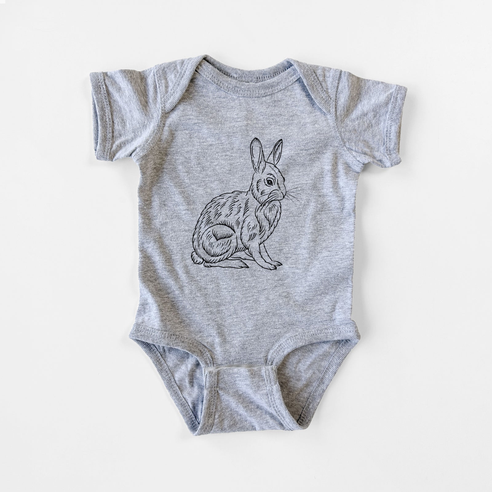 Grey baby bodysuit laid flat, printed with a detailed black ink illustration of a snowshoe hare sitting upright.
