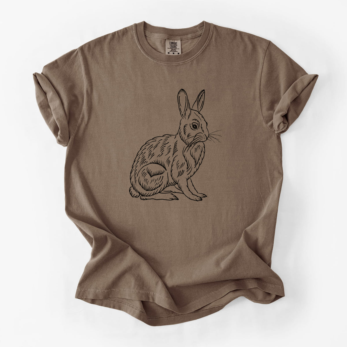 Espresso brown Comfort Colors t-shirt laid flat, printed with a detailed black ink illustration of a snowshoe hare sitting upright.