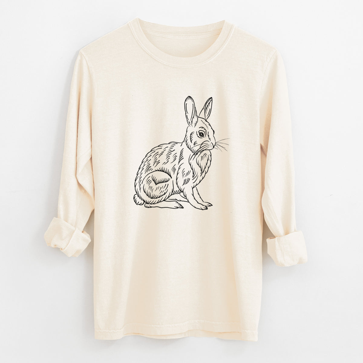Ivory Comfort Colors long sleeve shirt laid flat with the cuffs rolled, printed with a detailed black ink illustration of a snowshoe hare sitting upright.