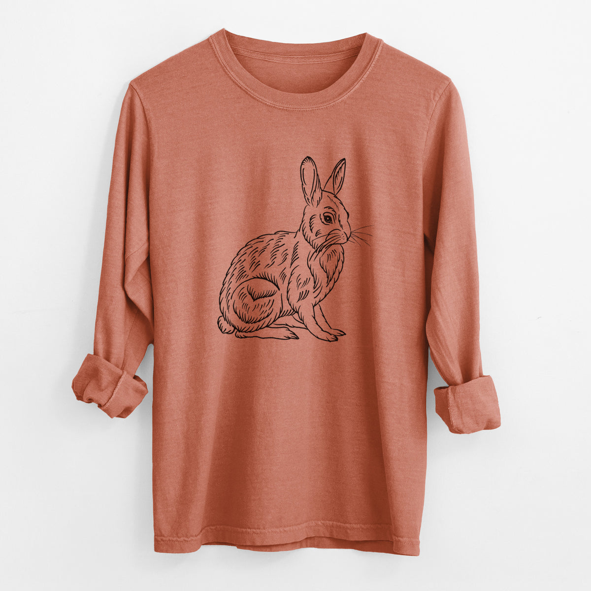 Yam burnt orange Comfort Colors long sleeve shirt laid flat with the cuffs rolled, printed with a detailed black ink illustration of a snowshoe hare sitting upright.