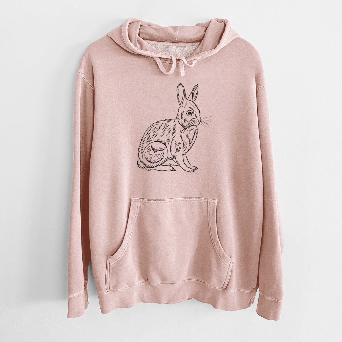 Dusty pink pigment dyed hoodie laid flat, printed with a detailed black ink illustration of a snowshoe hare sitting upright.