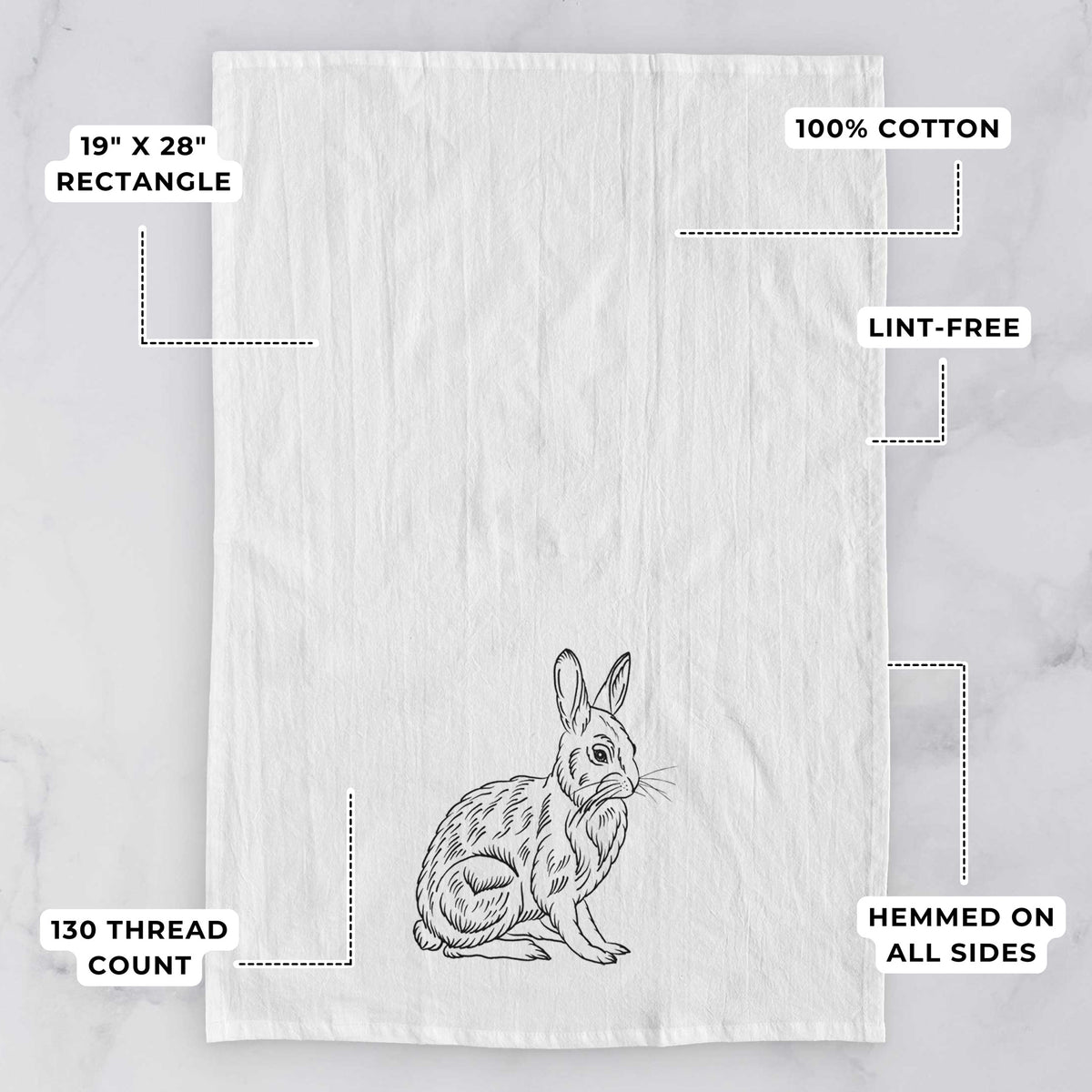 White tea towel printed with a detailed black ink illustration of a snowshoe hare sitting upright, with feature labels: 19 by 28 inch rectangle, 100% cotton, lint-free, 130 thread count, hemmed on all sides.