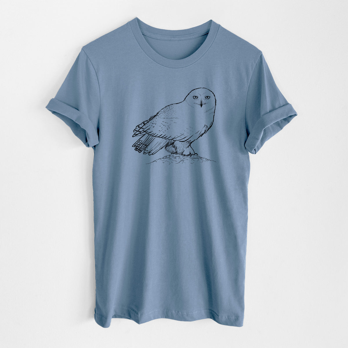 Steel blue lightweight cotton t-shirt laid flat, printed with a detailed black ink illustration of a snowy owl perched on a snowy mound.