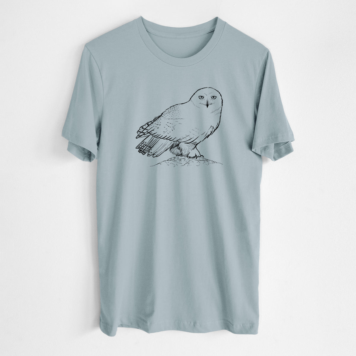 Vintage denim lightweight cotton t-shirt laid flat, printed with a detailed black ink illustration of a snowy owl perched on a snowy mound.