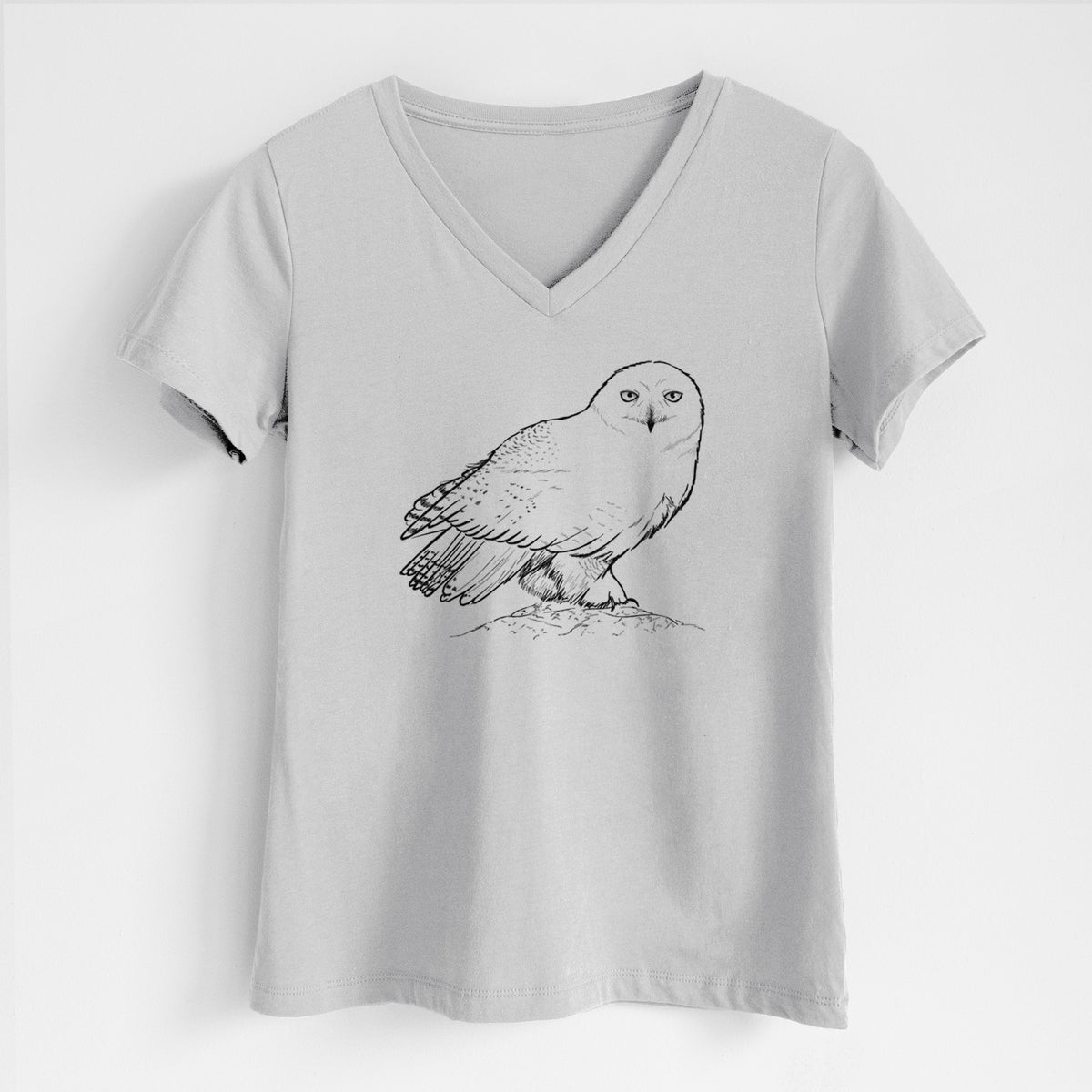 Lunar grey women's relaxed fit cotton V-neck t-shirt laid flat, printed with a detailed black ink illustration of a snowy owl perched on a snowy mound.