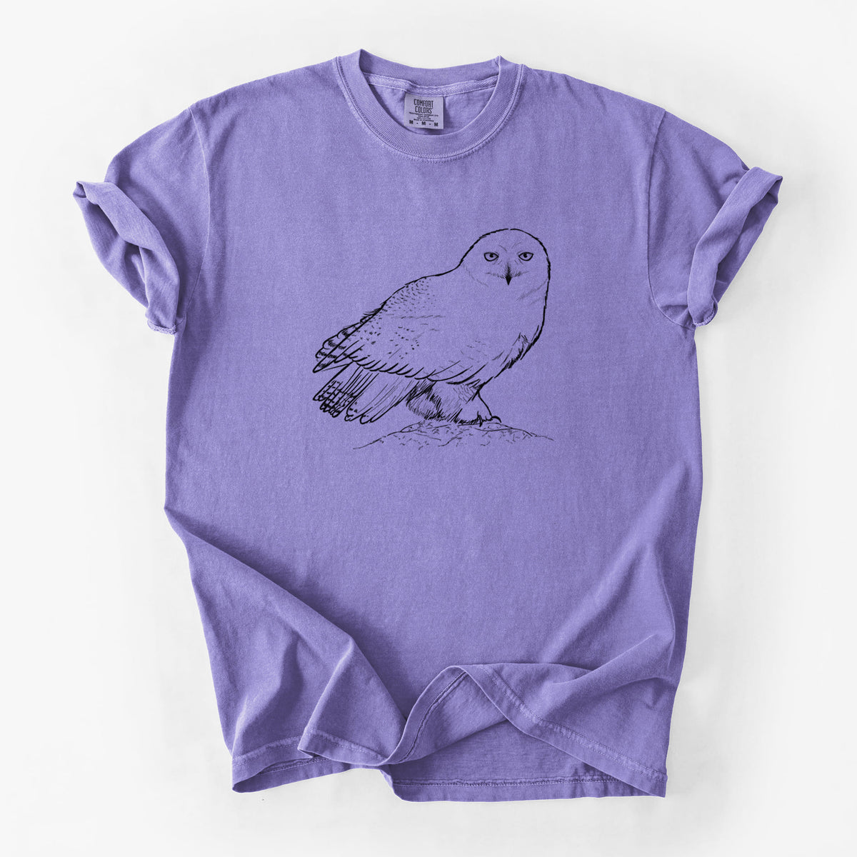 Violet purple Comfort Colors t-shirt laid flat, printed with a detailed black ink illustration of a snowy owl perched on a snowy mound.