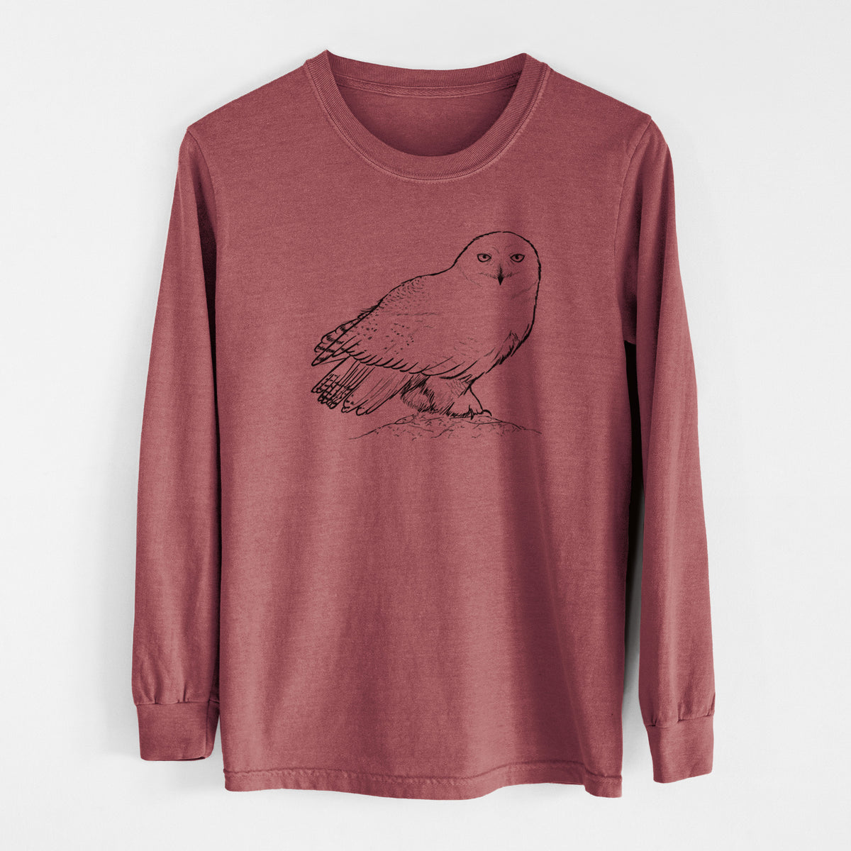 Brick red Comfort Colors long sleeve shirt laid flat, printed with a detailed black ink illustration of a snowy owl perched on a snowy mound.