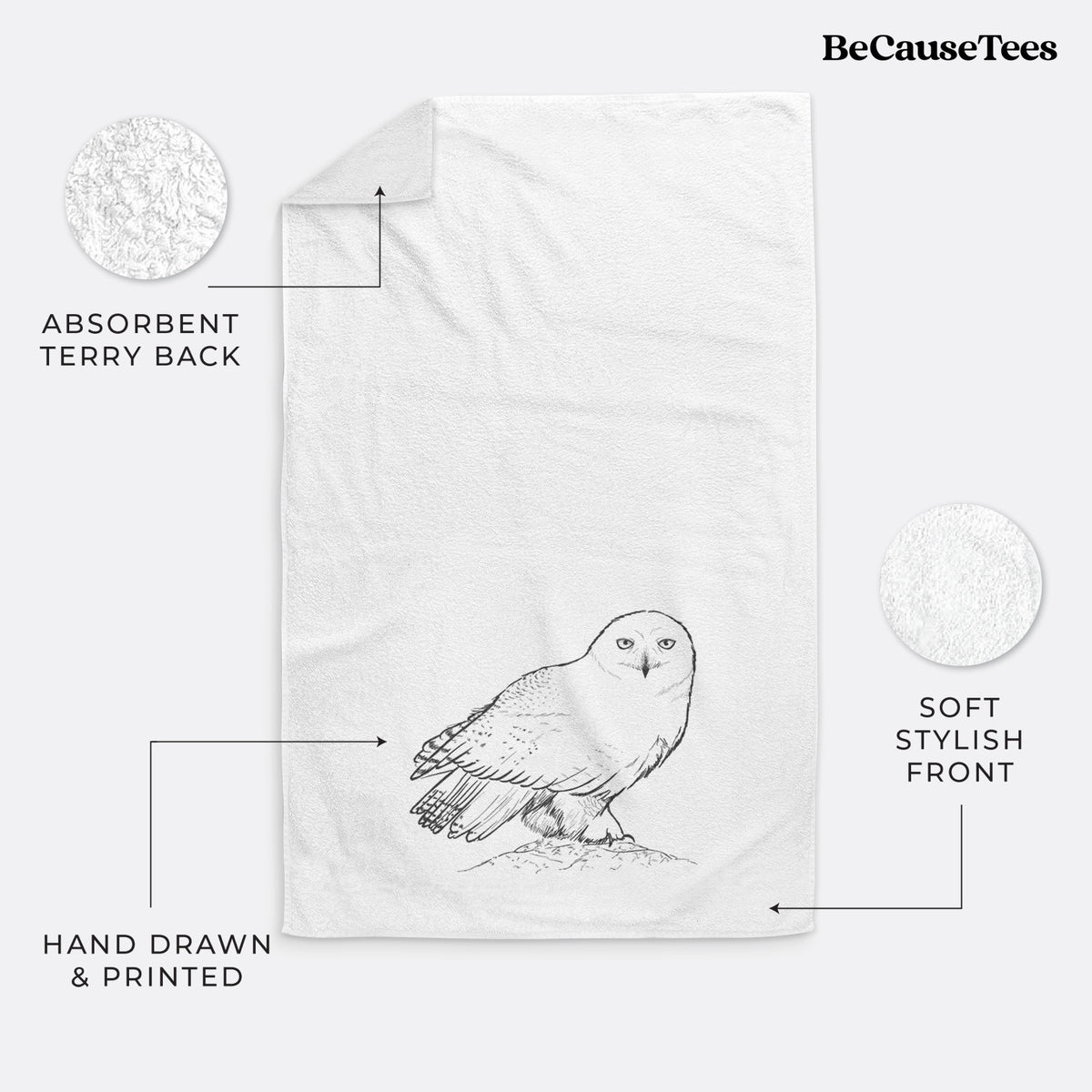 White hand towel printed with a detailed black ink illustration of a snowy owl perched on a snowy mound.