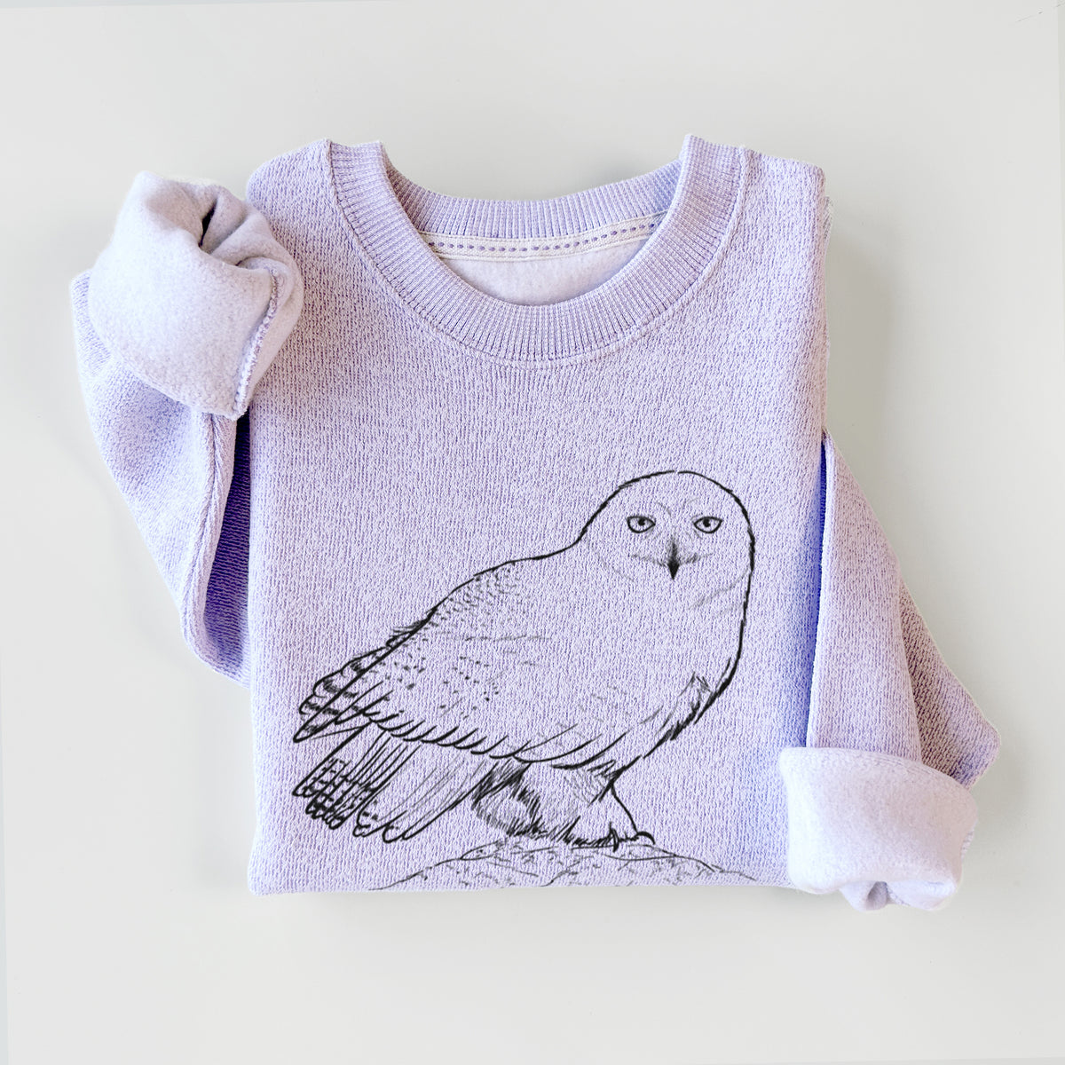 Ice purple knit sweatshirt printed with a detailed black ink illustration of a snowy owl perched on a snowy mound, styled flat.