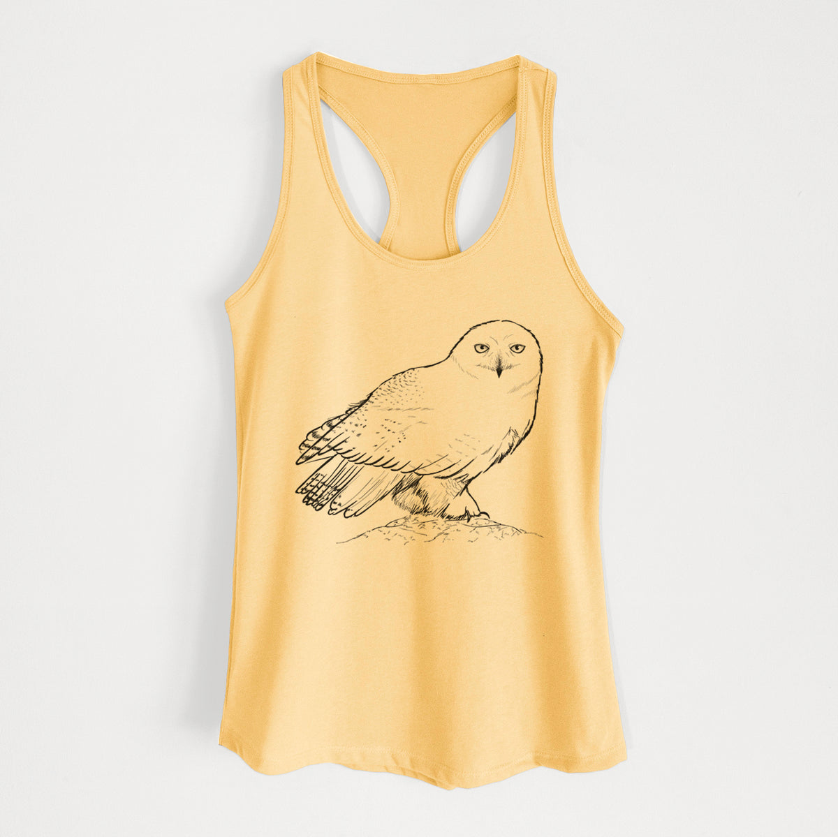 Banana cream women's racerback tank top laid flat, printed with a detailed black ink illustration of a snowy owl perched on a snowy mound.